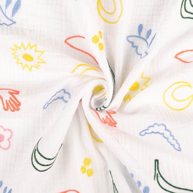 Katoenen mousseline geborduurd figuren wit